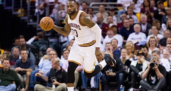 LeBron James playing basketball while thinking about his taxes