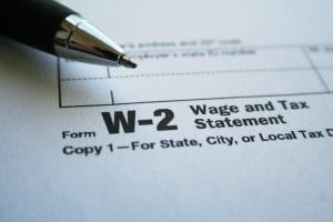 IRS Form W-2 with a pen