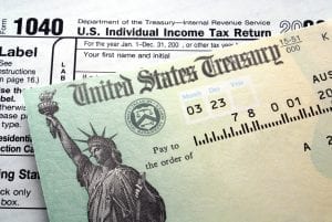 United States Treasury bill on top of IRS Form 1040