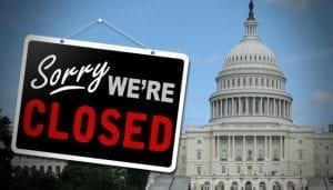 US capital with a sign reading "sorry, we're closed"