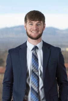 A young professional standing by Colorado's Front Range