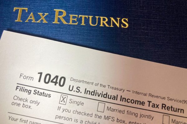 A 1040 tax form and a ledger reading "tax returns"