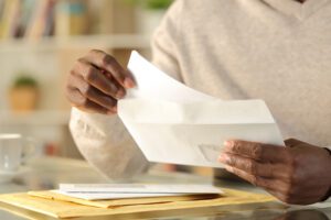 A man opens mail from the IRS